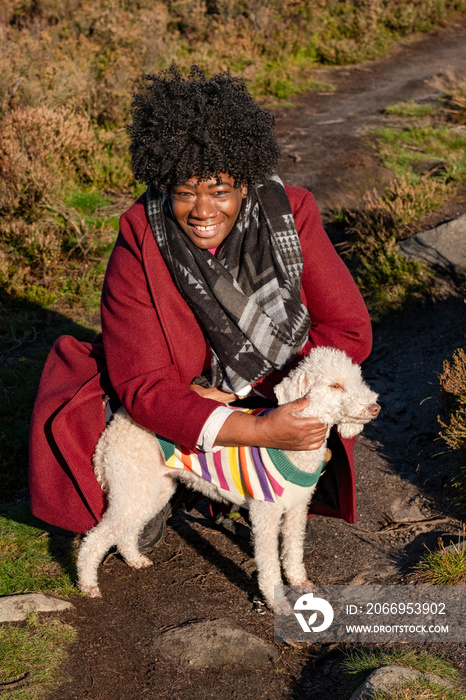 Senior woman with dog on footpath