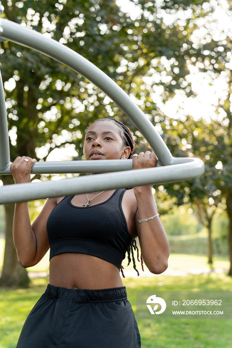 Young woman exercising in outdoor gym