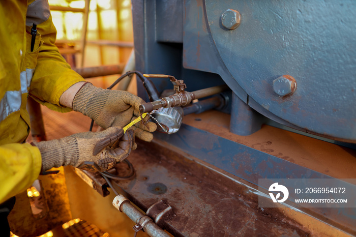 Miner electrician worker conducting safety inspection on wire cable tag power generator on the construction mine site plant, Sydney, Australia