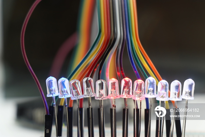 Light emitting diode or LED with glowing lights arranged in a breadboard and connected with jumper wires