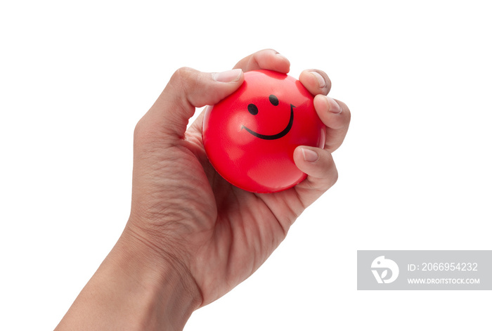 Hand squeezing a red stress ball isolated on white background with clipping path.