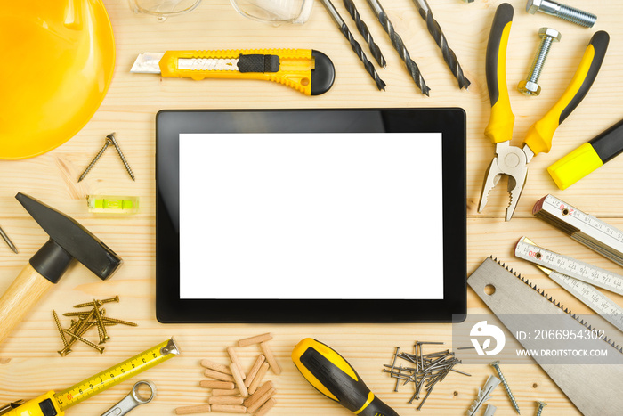 Digital Tablet and Assorted Carpentry Tools  on Workshop Table