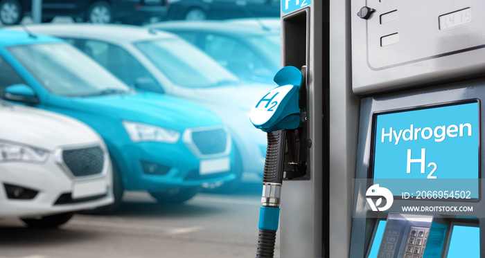 Hydrogen filling station on a background of cars. One car blue.