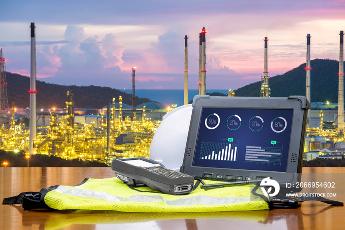 Smart factory - Rugged computers tablet in front of oil refinery