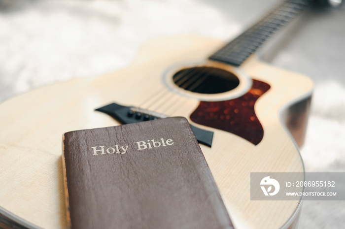 Christians worship God with a guitar with the Holy Bible. reading the Bible and sharing the gospel with copy space for the word of god.