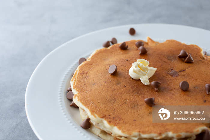 A view of a plate of chocolate chip pancakes.