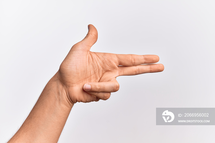 Hand of caucasian young man showing fingers over isolated white background gesturing fire gun weapon with fingers, aiming shoot symbol