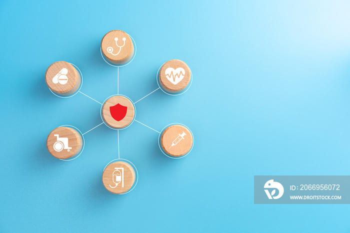 Health insurance concept, Hand holding a wood cubes with healthcare medical icon, blue background, copy space