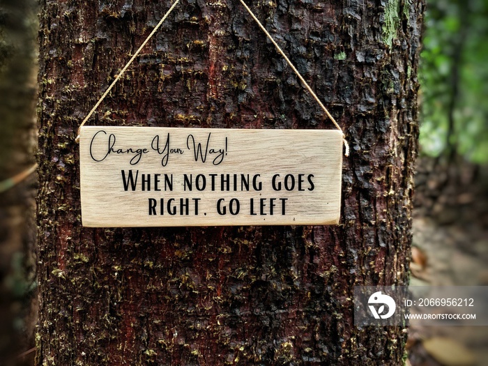 Motivational and inspiration quotes - When nothing goes right. Go left. With tree background. Motivational concept.