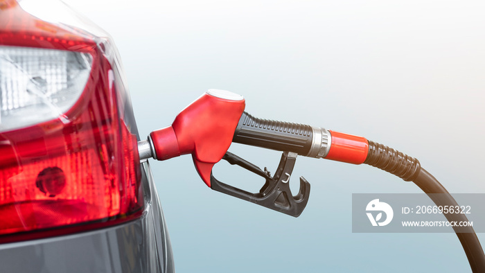 Car refueling  at gas station.With Red Fuel Nozzle