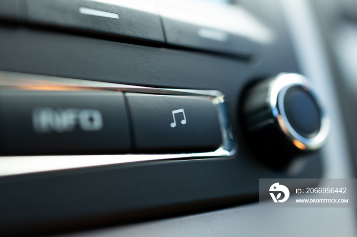 car audio media control panel. macro. auto sound repair service. music button close up