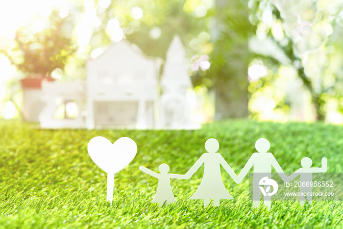 Family and house on green grass background,paper family concept.