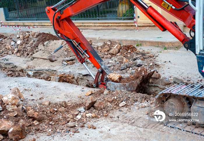 excavation with a narrow section to bury corrugated plastic cable ducts for the production of a fiber optic telecommunication cable distribution network.