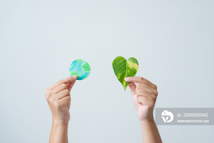 Eco friendly leaf as heart holding by woman hand concept of environmental conservation. Simplicity use of heart shape leave showing power of clean energy.