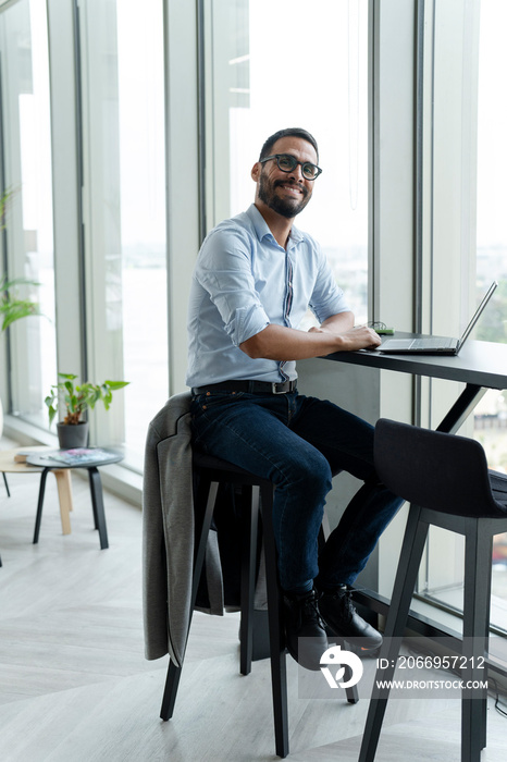 Businessman with laptop working in modern office