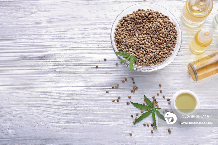 Beautiful composition with jar of hemp lotion on wooden background