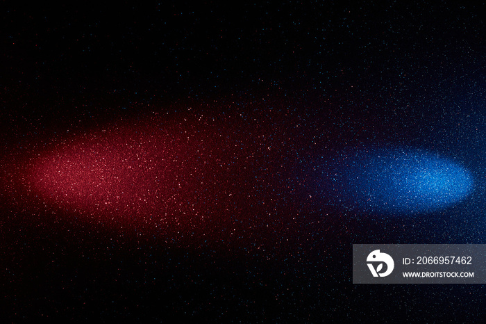 On a dark blue background with multi-colored grain, red and blue oncoming rays of light