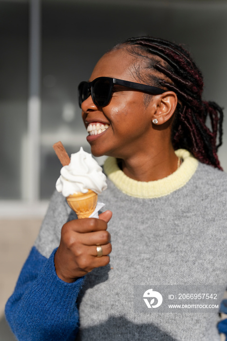 Smiling young woman eating ice cream