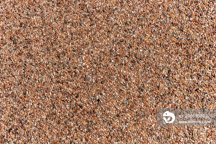 The pattern of dark brown small pebbles as background