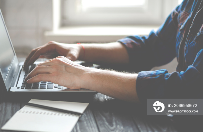 Freelancer works on a laptop in the home office