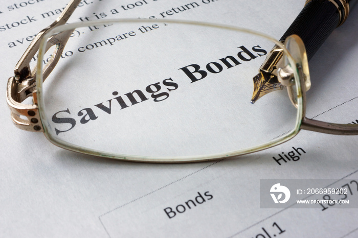 Page of newspaper with words savings bonds. Trading concept.