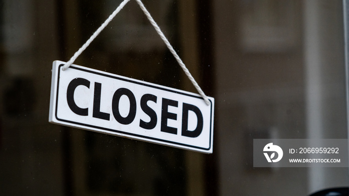 A closed sign on a shop window