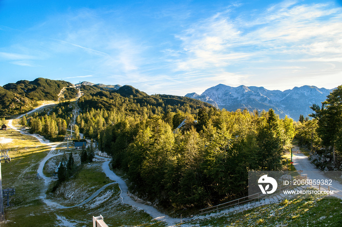 Rocky mountain peaks in the Julian Alps in Slovenia near the Vogel hill. Summer mountains and landscape over Lake Bohinj.