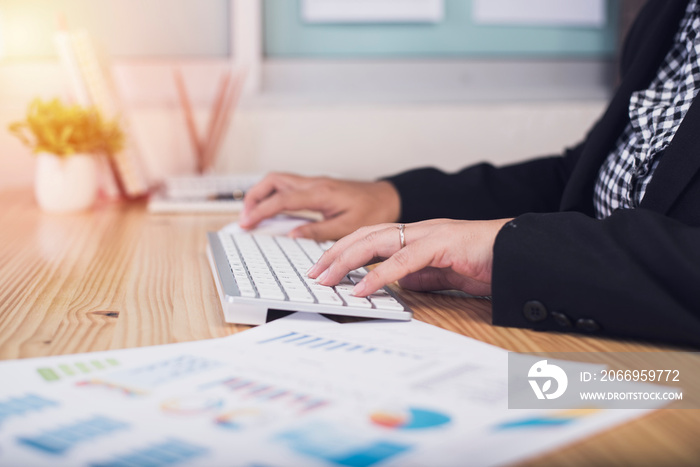 Asian business woman hands of an office worker woman typing keyboard.Financing Accounting Banking Concept.