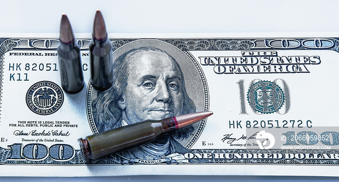 The bloody business of war. Bullets on dollar bills as symbol of terrorism, death, suffering, loss and violence.