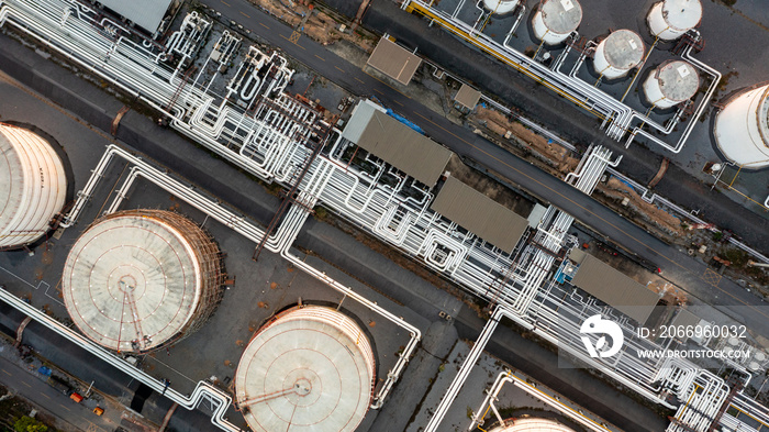 Aerial top view oil storage tank and pipeline at petrol industrial zone, Oil refinery plant industry, Refinery factory oil storage tank and pipeline petrochemical plant.