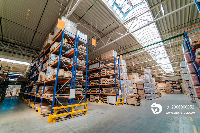 Rows of shelves with boxes in modern warehouse. Big pile of boxes in distribution warehouse. Closeup.