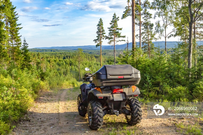 Quad / ATV on a dirt road somewhere in a Swedish forest