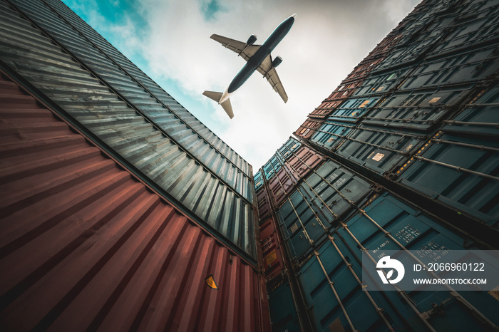 Freight airplane flying above overseas shipping container . Logistics supply chain management and international goods export concept .