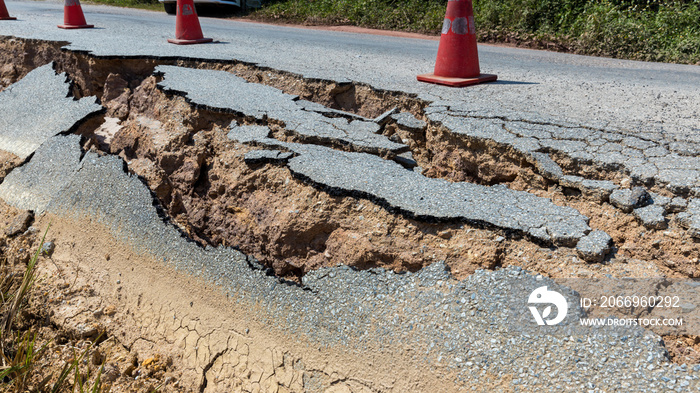 Landslide caused by rains occurs broken road asphalt. Broken asphalt road collapsed and fallen.  Road collapses. Cracked asphalt road. Construction site.