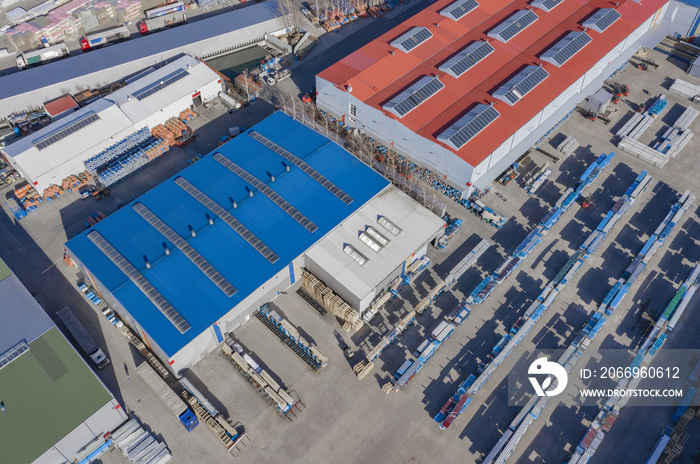 Aerial view of warehouse storages or industrial factory or logistics center from above. Aerial view of industrial buildings and equipment machines, toned