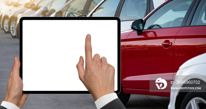 Hands with digital tablet on a background of rows of cars. Car sales.