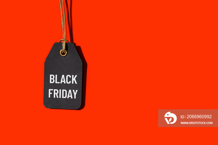 Black friday tag isolated on red background with copy space