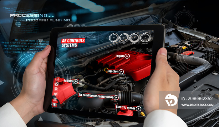 Engineer use augmented reality software to monitor parts of car vehicle with automated application . Futuristic machinery in working in concept of Industry 4.0 or 4th industrial revolution.