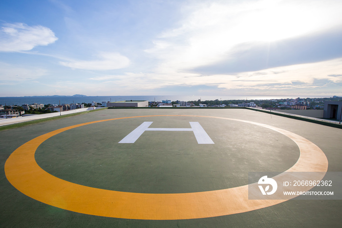 Symbols for helicopter parking on the roof of an office building. Empty square front of city skyline. Offshore helicopter parking pad on an offshore installation platform.