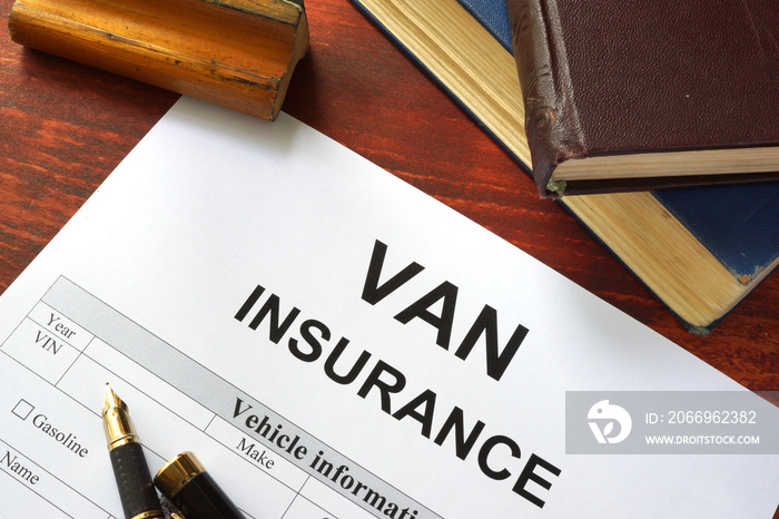 VAN insurance form on a table with a book.