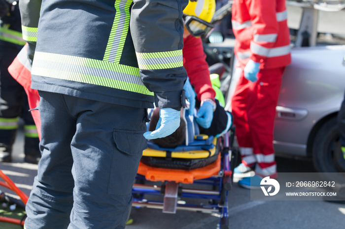 Paramedics and firefighters in a rescue operation after a car crash