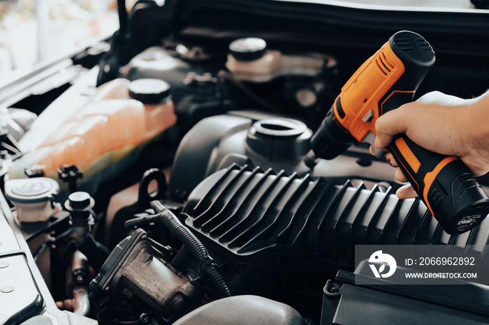 Automobile mechanic repairman hands repairing a car engine automotive workshop