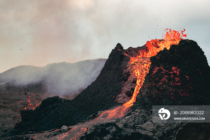 Volcanic eruption in Iceland, lava bursting from the volcano. Bright red magma.