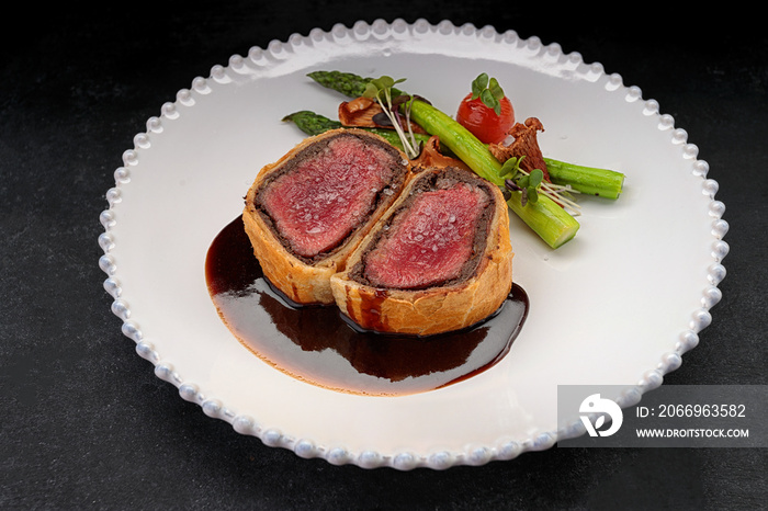 Beef Wellington with chanterelles, asparagus and black truffle with spicy Razmarin sauce