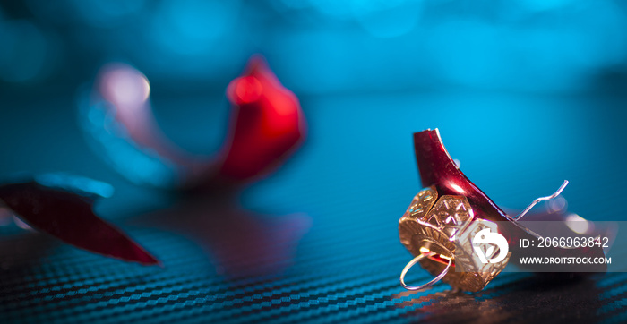 Broken Christmas ornament on a blue background that reflects the stress during the holidays