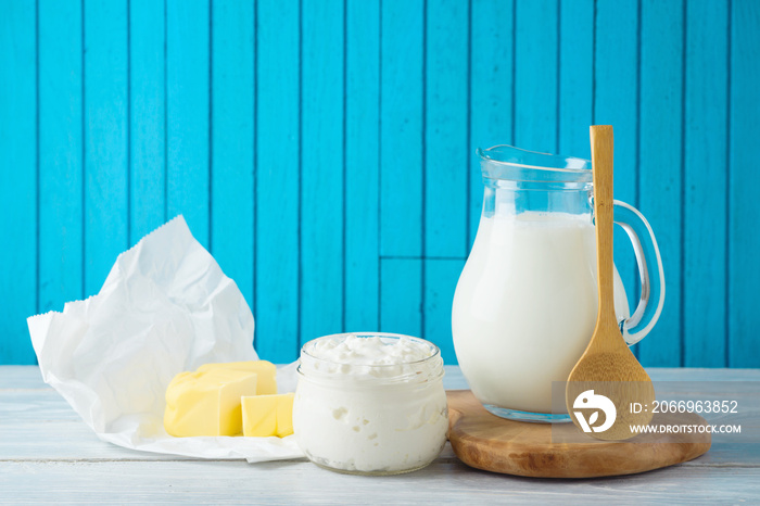 Jewish holiday shavuot background with milk, cottage cheese and butter on wooden table