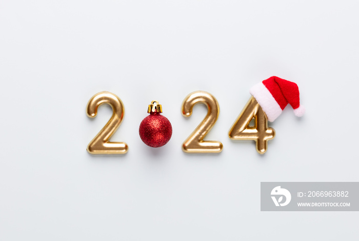 New year 2024 number, golden digits and santa hat over blue background.