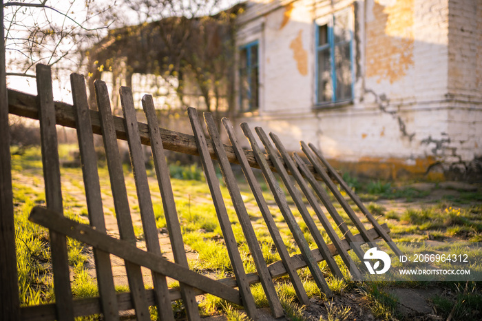 old wooden fence and country house