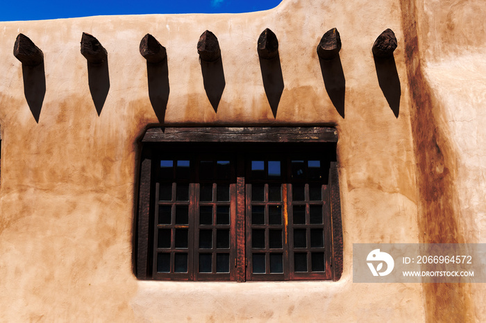 A window in a pueblo style wall