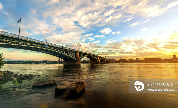 Beautiful sunset over Rhine / Rhein river and old bridge in Main